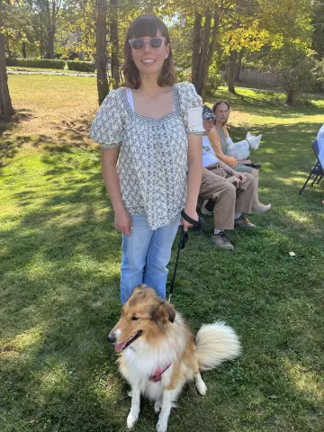 Sara Reilly standing with a dog